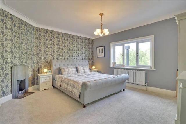 A fabulous double bedroom is at the rear of the house with a lovely garden outlook and feature decor to one wall. It has a period cast iron fireplace to the chimney breast wall.