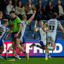 Harry Newman, second from right, celebrates scoring against Warrington Wolves, but coach Rohan Smith says Leeds Rhinos need to put more pressure on Huddersfield Giants this week. Picture by Bruce Rollinson.