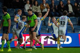 Harry Newman, second from right, celebrates scoring against Warrington Wolves, but coach Rohan Smith says Leeds Rhinos need to put more pressure on Huddersfield Giants this week. Picture by Bruce Rollinson.