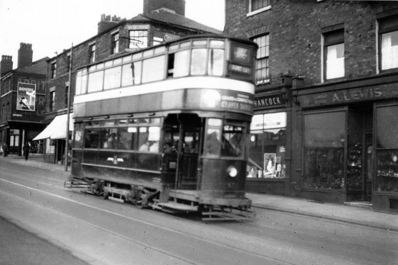 Tram no 67 on Woodhouse Lane in  September 1954. The junction with Exeter Place can be seen far right. A Lewis General Dealer can be seen on right at 102 Woodhouse Lane.