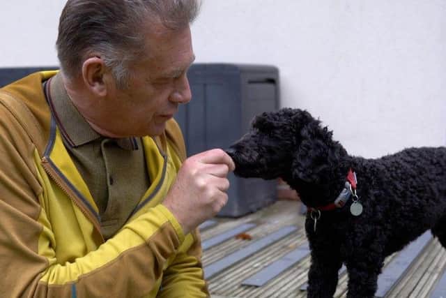 Chris meeting hearing dog puppy-in-training Theo for the first time.