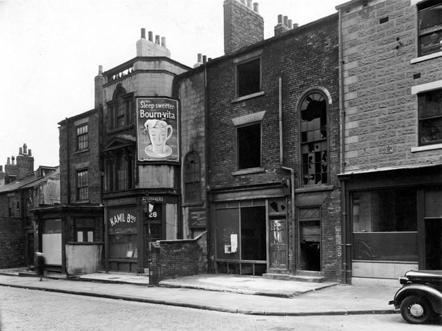 Derelict premises on Camp Road and 'Kamil Bros, upholsterers' at number 28. Advert for 'Cadbury's Bourn-vita'. Pictured in July 1951.