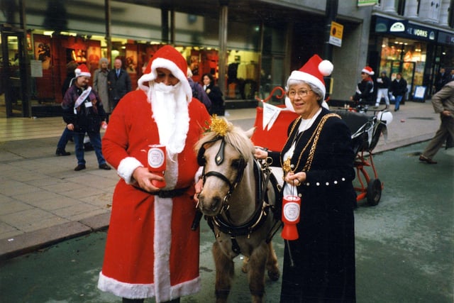 Coun Linda Middleton, Lord Mayor of Leeds 1997-98, is seen on Briggate with Father Christmas and a pony pulling a sleigh, collecting for the charity Childline in December 1997. Marks & Spencer can be seen in the background, with the Works bookshop to the right. Coun Middleton represented Middleton ward between 1986 and 2002.