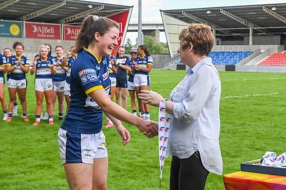 Rhinos' Izzy Northrop receives her player of the match medal from RFL vice-president resident Sue Taylor following the nines final win over Wigan at Salford. Picture by Olly Hassell/SWpix.com.