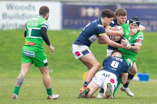 Michael Knowles is tackled by Ben Littlewood (left), Tom Nicholson-Watton and Freddie Brennan-Jones (number eight) during Hunslet's pre-season with over Leeds. Picture by Craig Hawkhead/Leeds Rhinos.