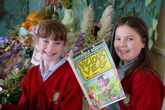 Pupils at St Oswald's Primary read Horrible History books as part of their Harvest Festival celebrations in October 2003. Pictured are Year 6 pupils Hannah Rebecchi and Emily Elsworth.