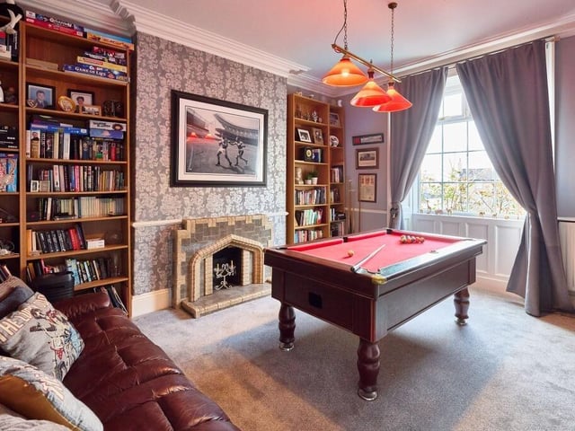 The games room has bespoke built-in bookcases that maximise the space in the alcoves, either side of the original 1920’s tiled fireplace which remains as a nod to the period heritage.