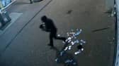 A suspected burglar flees the scene of a theft, dropping trading cards on the pavement