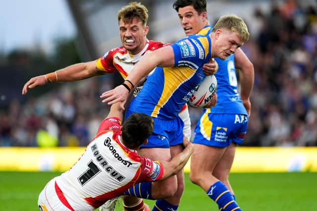 Leeds Rhinos' James McDonnell is tackled by Arthur Mourgue of Catalans Dragons. Picture by Olly Hassell/SWpix.com.