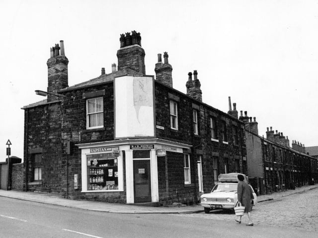 Fountain Street at the junction with Little Fountain Street in August 1968. The shop is a tobacconist and confectioners owned by M. and M. Knowles. The bridge over the railway lines can be seen to the left. A woman is crossing Little Fountain Street in front of a parked car.