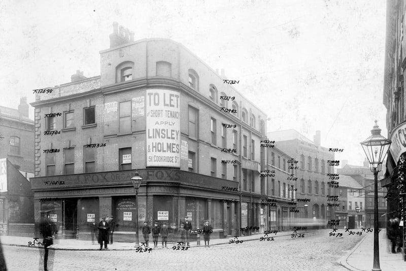 The junction of Swinegate and Sovereign Street in August 1904. On the corner, J. Fox musical instruments shop has 'To Let' signs. On Swinegate, towards, the right, can be seen Ye Olde Dustye Miller Inn at number 9, landlord William Jackson. Next on the right, number 10, was Thomas Beecroft & Co Electroplaters and engineers.