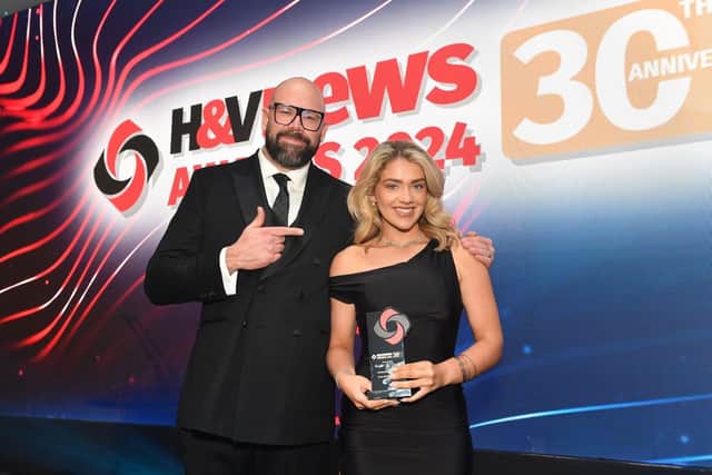 Comedian and actor Tom Davis presenting Olivia Hullah, Marketing Manager at Trust Electric Heating, with award.