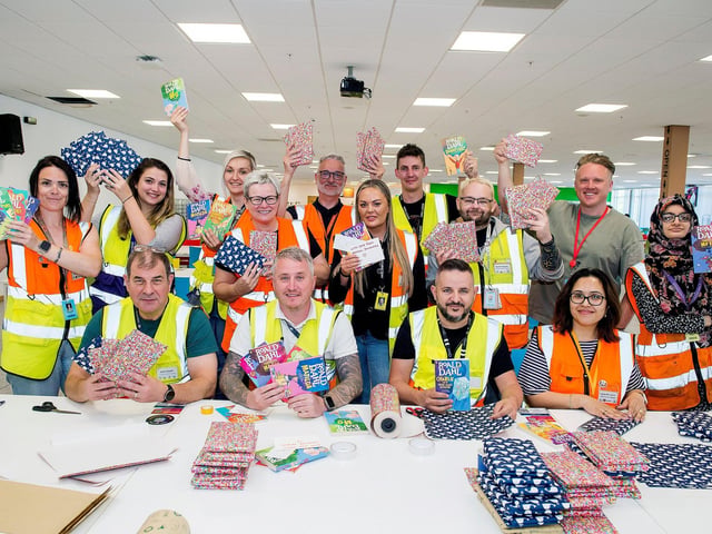 Staff from Amazon, Doncaster, packing books with a written message for a local Multibank.