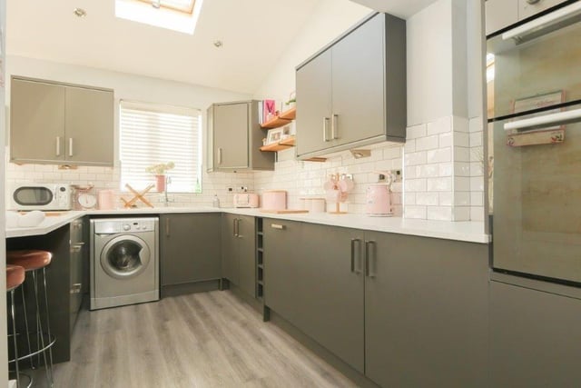 The heart of the house is the kitchen and combined living room, which has an excellent range of storage units and integrated appliances, plus space for a sofa and dining table.