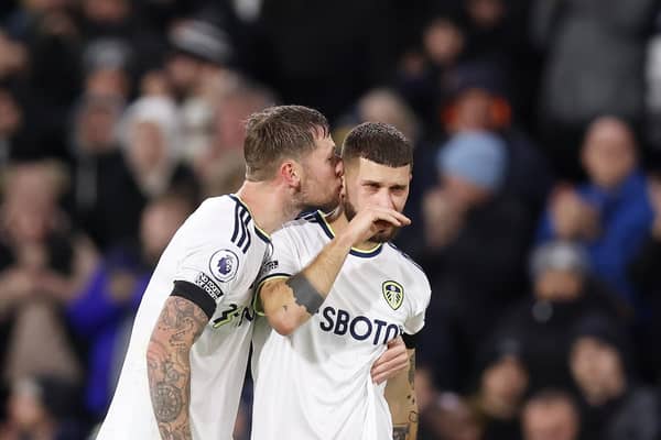LEEDS, ENGLAND - JANUARY 04: Mateusz Klich (R) of Leeds United is embraced by teammate Liam Cooper following his team's draw in the Premier League match between Leeds United and West Ham United at Elland Road on January 04, 2023 in Leeds, England. (Photo by George Wood/Getty Images)