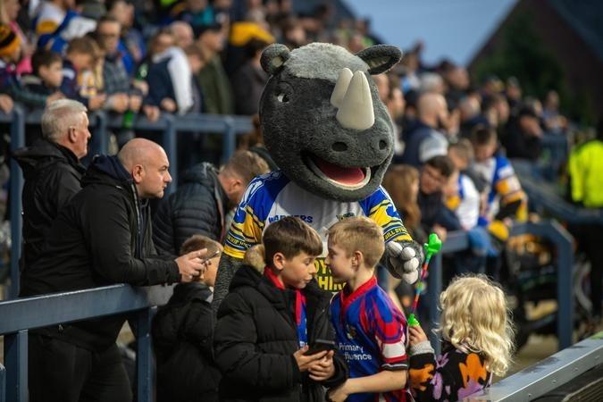 Mascot Ronnie Rhino with young fans at the game against London.