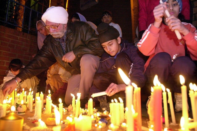 Pictured people lighting candles at Leeds Road Temple in celebration of Diwali, the festival of light on November 14, 2001.