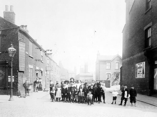 Taken from Waterloo Road, looking down Bower Row prior to the Waterloo Road improvements in August 1904. On the right is an empty unidentified retail premises, next to this is a large poster advertising Taylor's Drug Co. Further down the street is a house called Claremont House which has wooden carts in the yard. Towards the rear of the street, which is a cul-de-sac, it is possible to see the rear of the Grey Mare Inn which is located on Low Road beyond. 