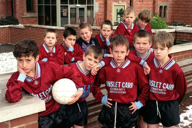 Footballer Ryan Golden (left), captain of Hunslet Carr Primary  U-10s stands with his teammates after being left without transport for away games since the school bus was stolen by heartless thieves.