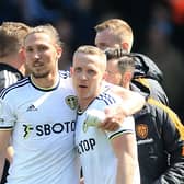 Leeds United's English defender Luke Ayling hugs Leeds United's English midfielder Adam Forshaw (Photo by LINDSEY PARNABY/AFP via Getty Images)