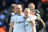 Leeds United's English defender Luke Ayling hugs Leeds United's English midfielder Adam Forshaw (Photo by LINDSEY PARNABY/AFP via Getty Images)