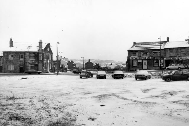 Looking across to Lowtown at the junction with Hough Side Road, from snow-covered wasteland in the foreground in January 1982. On the left is the Victoria Hotel. To the right are Polymax Belting Ltd. and Charles Smith, greengrocer.