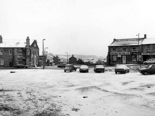 Looking across to Lowtown at the junction with Hough Side Road, from snow-covered wasteland in the foreground in January 1982. On the left is the Victoria Hotel. To the right are Polymax Belting Ltd. and Charles Smith, greengrocer.