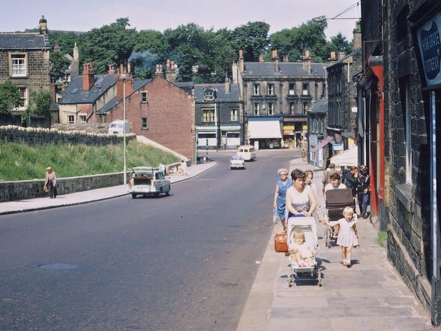 Looking down the final part of Scatcherd Hill into Morley Bottoms. The view is taken outside Jack Wilcock's shop and the buildings on the right hand side are as they have been for many years but on the left hand side there has been widespread clearance of shops, the road has been widened, the pavement widened and a banking made for shrubs and bulbs. Pictured in August 1967.