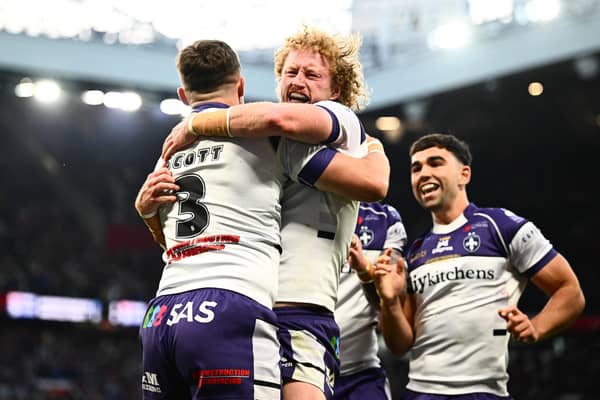 Lachlan Walmsley, centre of picture, celebrates with Cam Scott, left, after the latter's try for Wakefield Trinity in the Grand Final win against Warrington Wolves. Picture by Olly Hassell/SWpix.com.