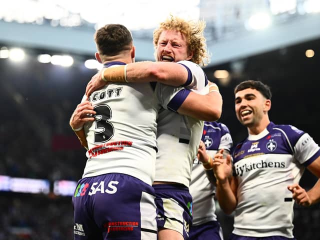 Lachlan Walmsley, centre of picture, celebrates with Cam Scott, left, after the latter's try for Wakefield Trinity in the Grand Final win against Warrington Wolves. Picture by Olly Hassell/SWpix.com.