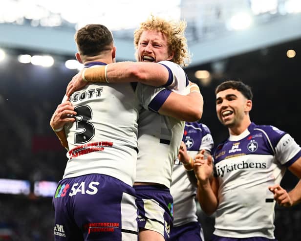 Lachlan Walmsley, centre of picture, celebrates with Cam Scott, left, after the latter's try for Wakefield Trinity in the Grand Final win against Warrington Wolves. Picture by Olly Hassell/SWpix.com.