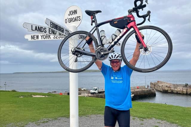 Geoff Taylor, funeral service manager at Harrogate's Co-op Funeralcare, celebrates at John O'Groats