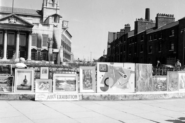 A summer exhibition of paintings held around the gardens in front of the Civic Hall on July 13, 1967. The paintings are the work of Leeds Painting and Sketching Club and feature landscapes, still life and abstract works. The club met at the Leeds Civic Arts Guild at 43 Cookridge Street, on a weekly basis. Leeds Civic Hall is in the background, left.