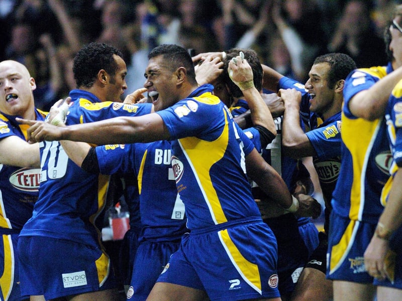 Ali Lauitiiti leads the celebrations as Danny McGuire is mobbed following his late try.