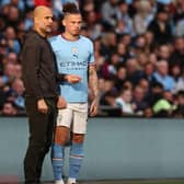 CONFIDENCE: In Kalvin Phillips, right, from Manchester City boss Pep Guardiola, left. Photo by ADRIAN DENNIS/AFP via Getty Images.