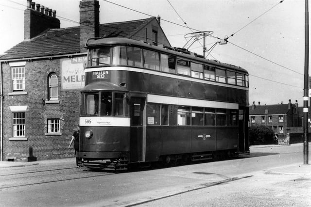 View of tram no.585 outside the New Inn public house on Tong Road, the tramway terminus for Wortley. One of 90 Felthams which came to Leeds from London, it is here about to turn around to make the journey to Halton on route 20. Houses on Albany Street can be seen in the background on the right. Pictured in July 1956.