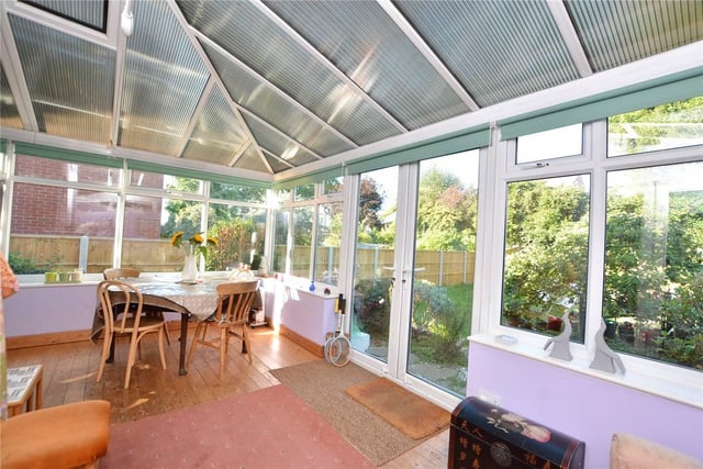 Across the rear of the house is an 'L' shaped conservatory with double doors opening onto the garden.