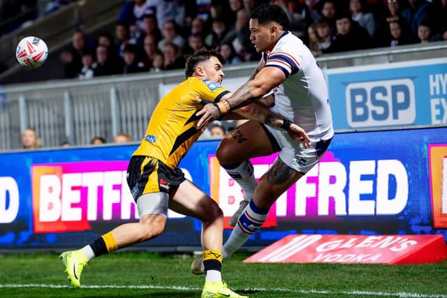 Wakefield Trinity's Renouf Atoni offloads out of a tackle by Tex Hoy during last week's win agianst Castleford Tigers. Picture by Allan McKenzie/SWpix.com.