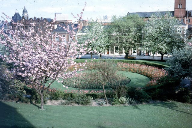 This springtime view of Woodhouse Square was taken from a window of number 2 Claremont Avenue. The view looks left across the Inner Ring Road and Great George Street. The conical tower far left and red brick building belongs to the former Centaur Clothing Factory. It was converted into residential apartments in 1998. Behind to the right, the dome of the Town Hall is visible. The central buildings are part of Swarthmore Education Centre. The building in the background, right, is the former factory premises of John Barran & Sons Limited, Wholesale Clothing Manufacturers, on the west side of Chorley Lane. Joseph's Well, a Public House, now occupies part of the building.