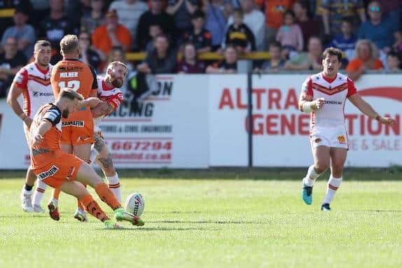 Danny Richardson kicks the golden point winning drop goal in Tigers' win over Catalans. Picture by John Clifton/SWpix.com