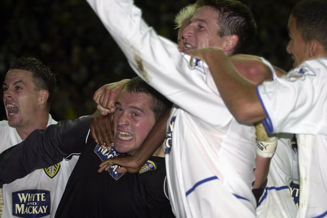 Goalkeeper Paul Robinson is mobbed by his team-mates after scoring a header that sent Leeds United's League Cup clash against Swindon Town into extra-time. The Whites won on penalties.