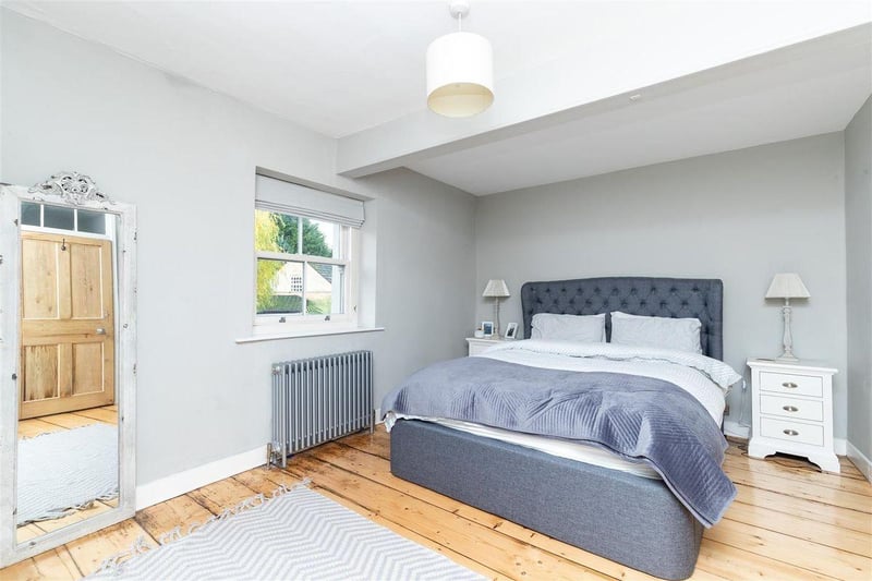 The master bedroom is a great size, with original stripped wooden flooring and a reclaimed door. An original radiator and double glazed sash window are also stand-out features.