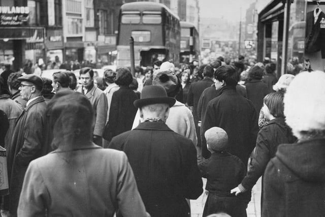 Briggate packed with slowly moving Christmas shoppers in December 1965.