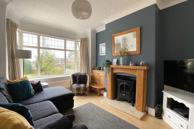 The lounge has a bay window, allowing for ample natural light to fill the room,