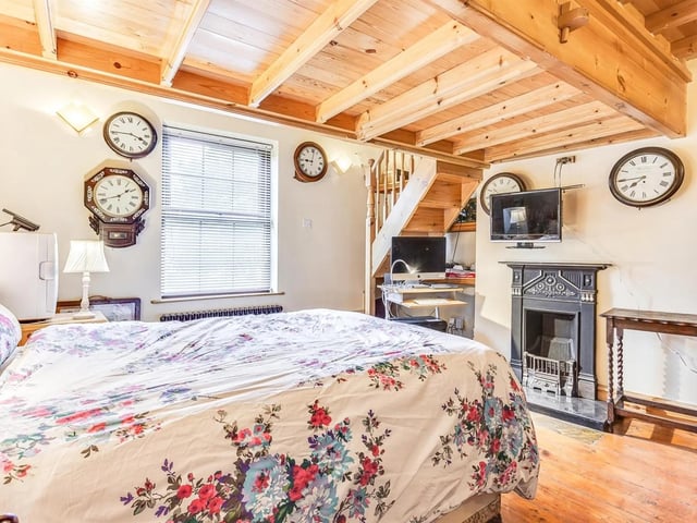 This home has an internal stone floor staircase, and the main bedroom, seen here, has a mezzanine level.