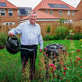 Sales Director, Paul Hogan, with the water butt and watering can being issued by Barratt and DWH
