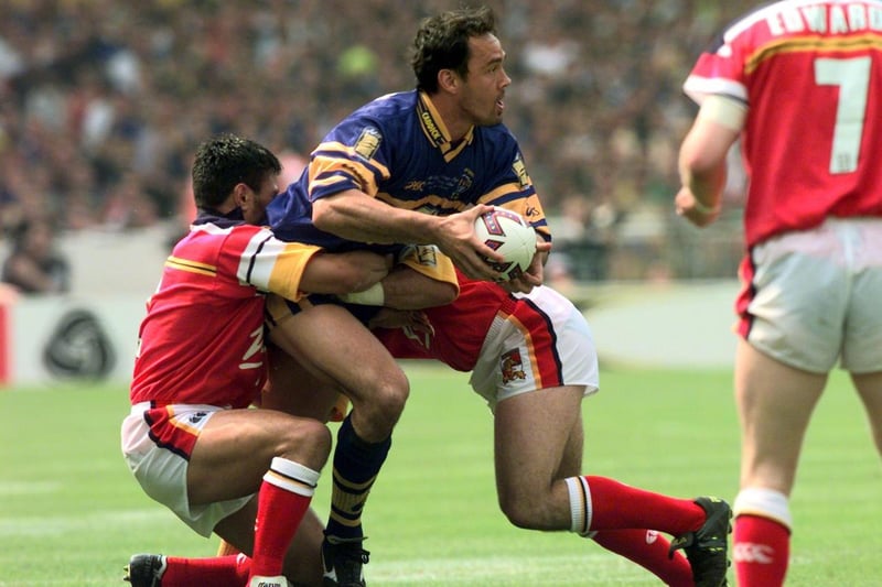 Rhinos' New Zealand centre Richie Blackmore is stopped by the Broncos defence.