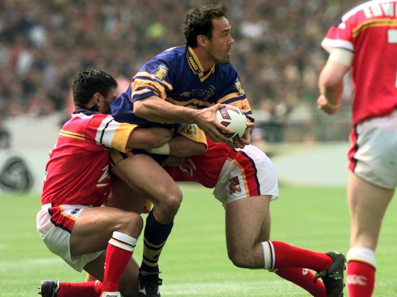 Rhinos' New Zealand centre Richie Blackmore is stopped by the Broncos defence.