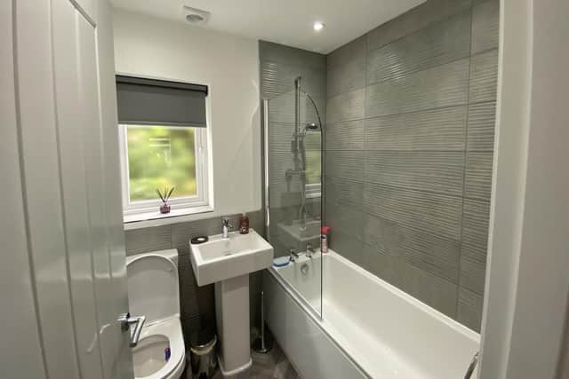 There is a luxurious main bathroom and further downstairs cloakroom as well (Image shows an occupied three-bedroom detached property, not a show home)