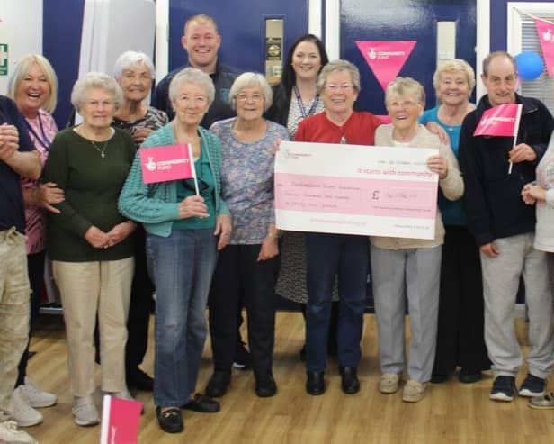Celebrating with the Cheque from the National Lottery